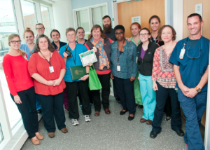 Teresa Radford and her team on 3 West gather to celebrate her DAISY Award for excellence in nursing.