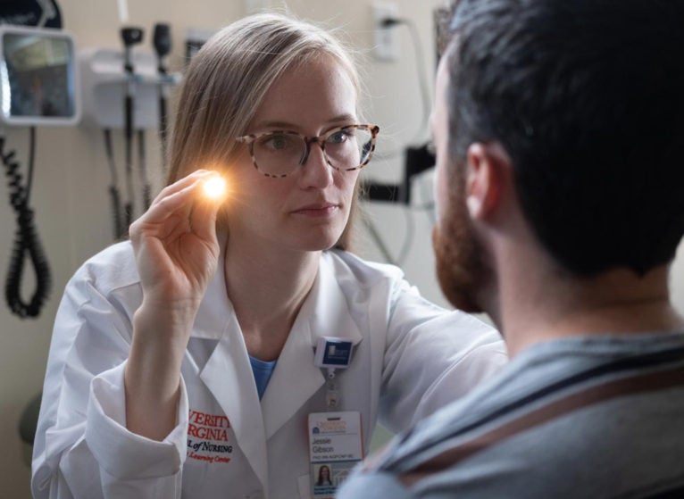 University of Virginia nurse scientist Jessie Gibson, who studies Huntington’s disease, performs a mock neurological exam on a patient. (Photo by Coe Sweet