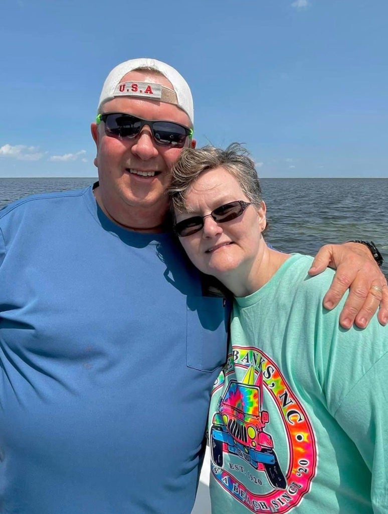 Retired Coast Guard accountant Wendy Conner at the beach with Don, her husband of seven years and caregiver. Conner, a patient at UVA’s Huntington’s Clinic, was diagnosed with the disease at 52. (Contributed photo)