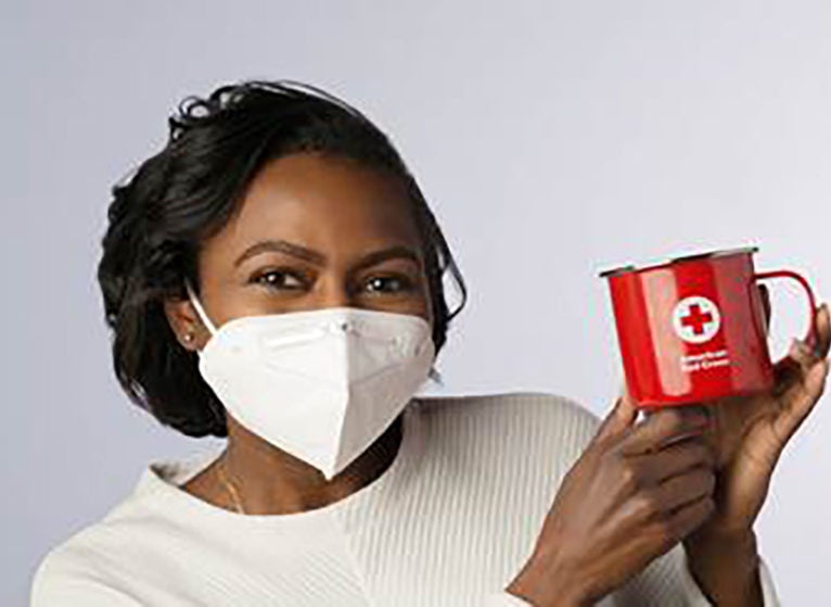 woman with red cross mug