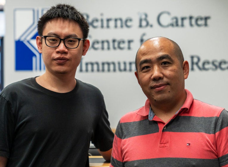 Jinyi Tang, research associate at UVA Health, stands with coordinator Jie Sun of the University’s Carter Immunology Center. (Erin Edgerton, University Communications)