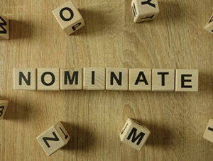 Nominate word from wooden blocks on desk