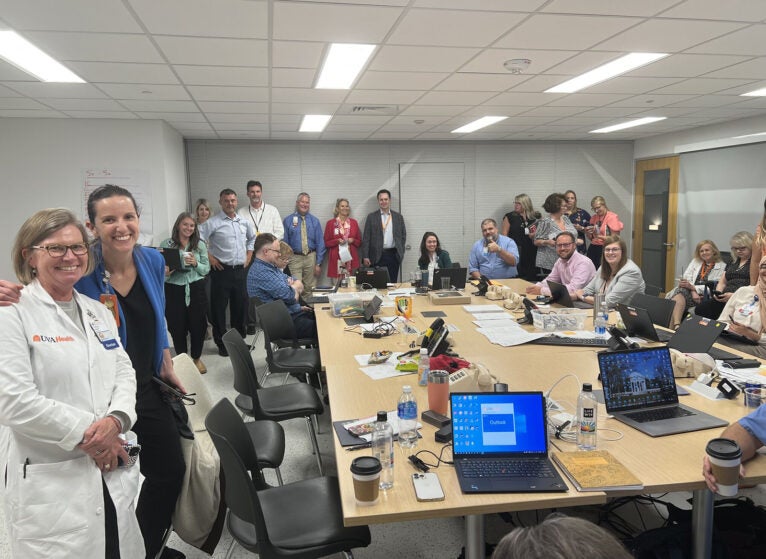 (l-r) Dr. Tracey Hoke, Veronica Brill, and team members inside The Incident Command Center.