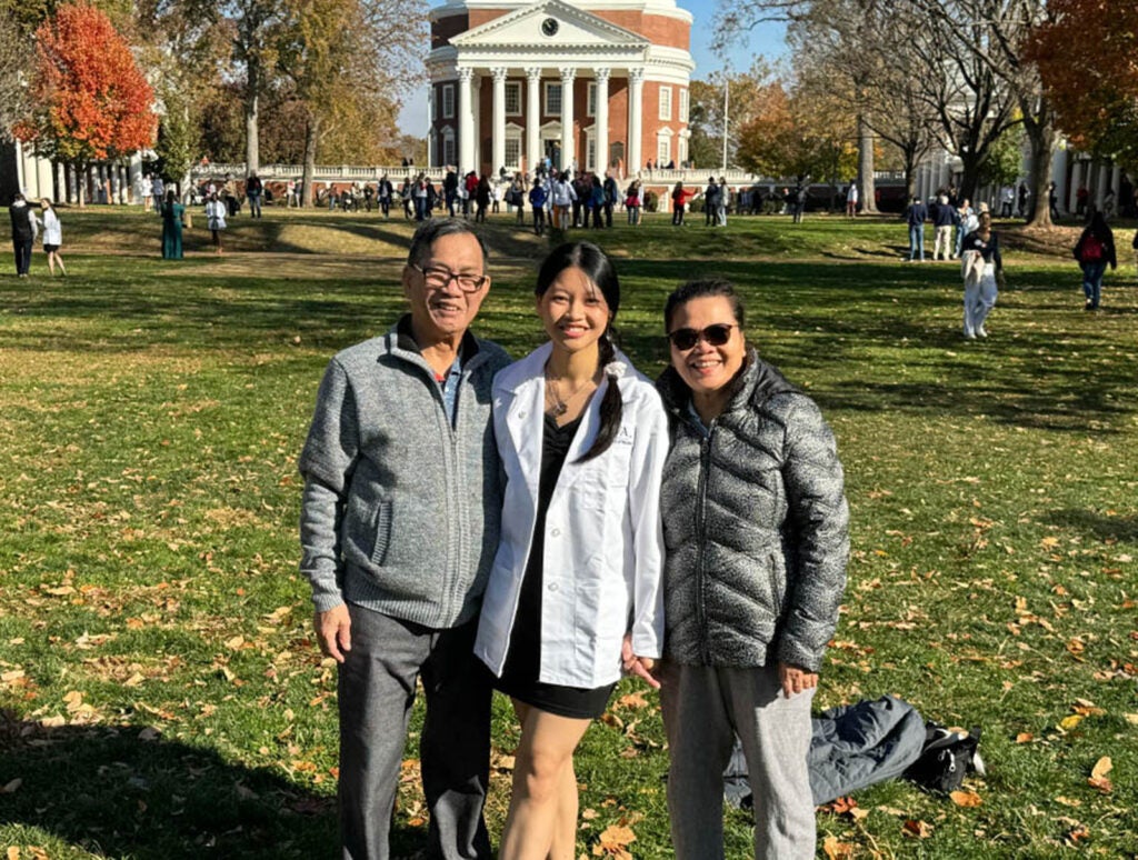 Tran and her family pose on UVA's storied Lawn at the Undergraduate Recognition and White Coat ceremony.