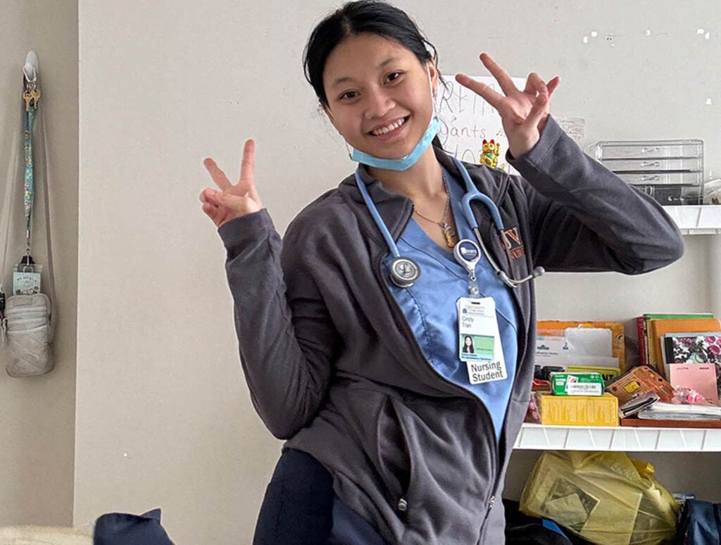 Tran, who completed the prerequisites required for the 3-Year BSN Transfer program at Northern Virginia Community College, strikes a pose in her UVA School of Nursing scrubs.