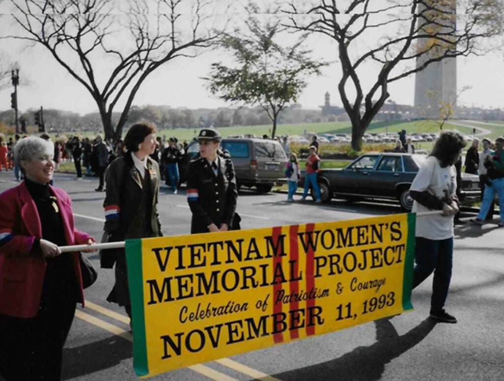 Diane Carlson Evans, the nurse who spearheaded the 10-year campaign for a memorial, walks behind the banner during the parade in Washington, DC. Courtesy of the Vietnam Women's Memorial Foundation.