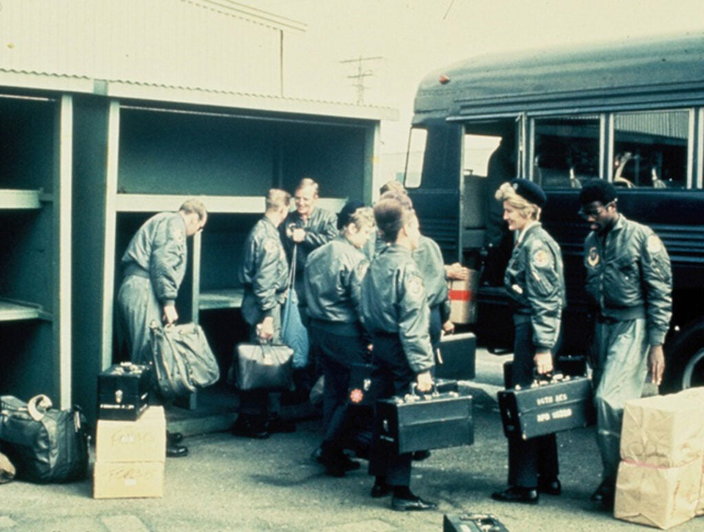 A flight crew loads gear onto a bus for another medical mission during the Vietnam War. Dianne M. Gagliano Collection, ECBCNHI.