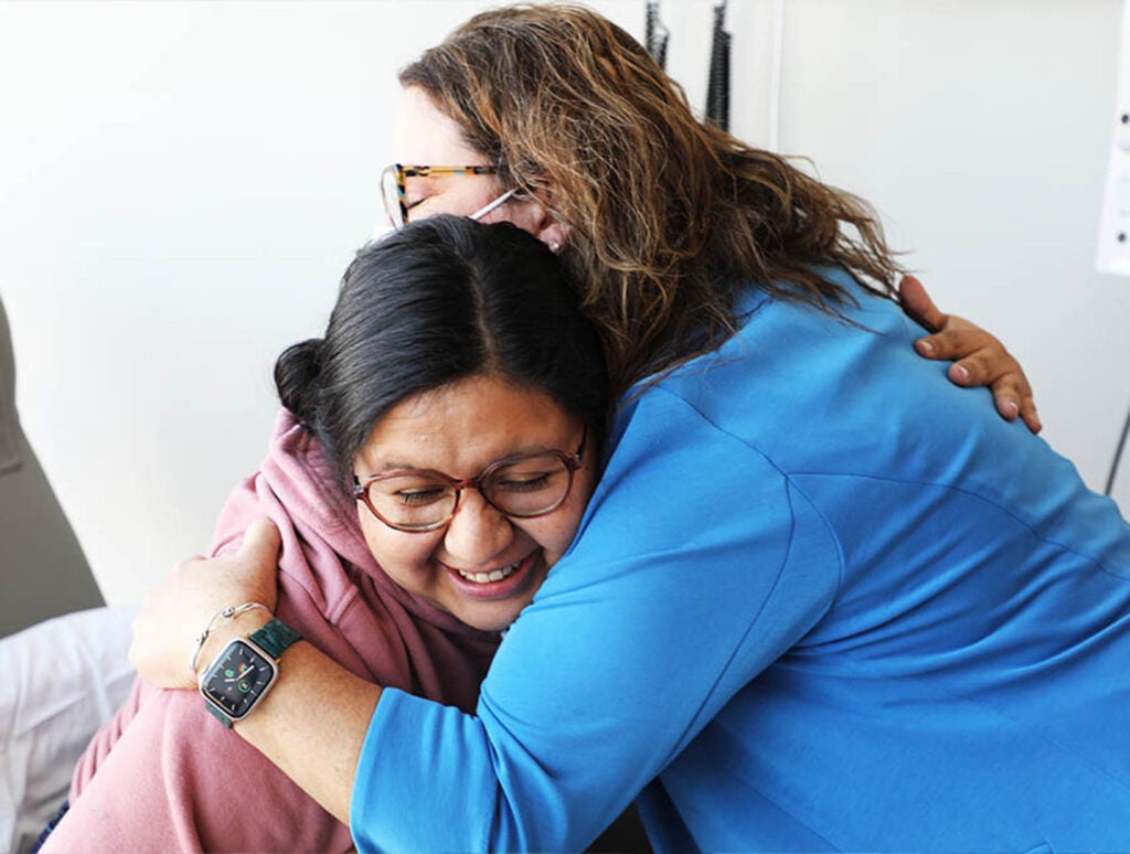 Murray hugs Candice Hines, Lincoln's mom, at a recent visit.