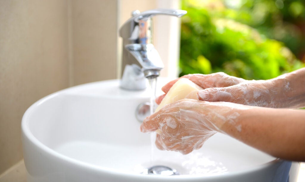 Senior woman washing hands