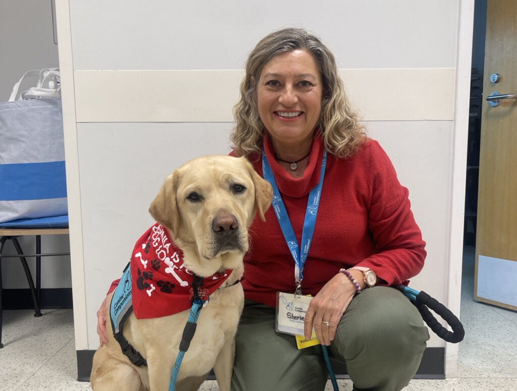 Pet Therapy Volunteer Team Spector and Sherie Bors-Kofoed wearing red to visit the children's hospital today!