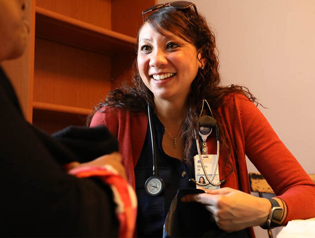 A faithful presence at weekly pop-up clinics in underserved communities across Charlottesville, Whitlow is one of two nurse practitioners on faculty who provide care aboard a new mobile care van.