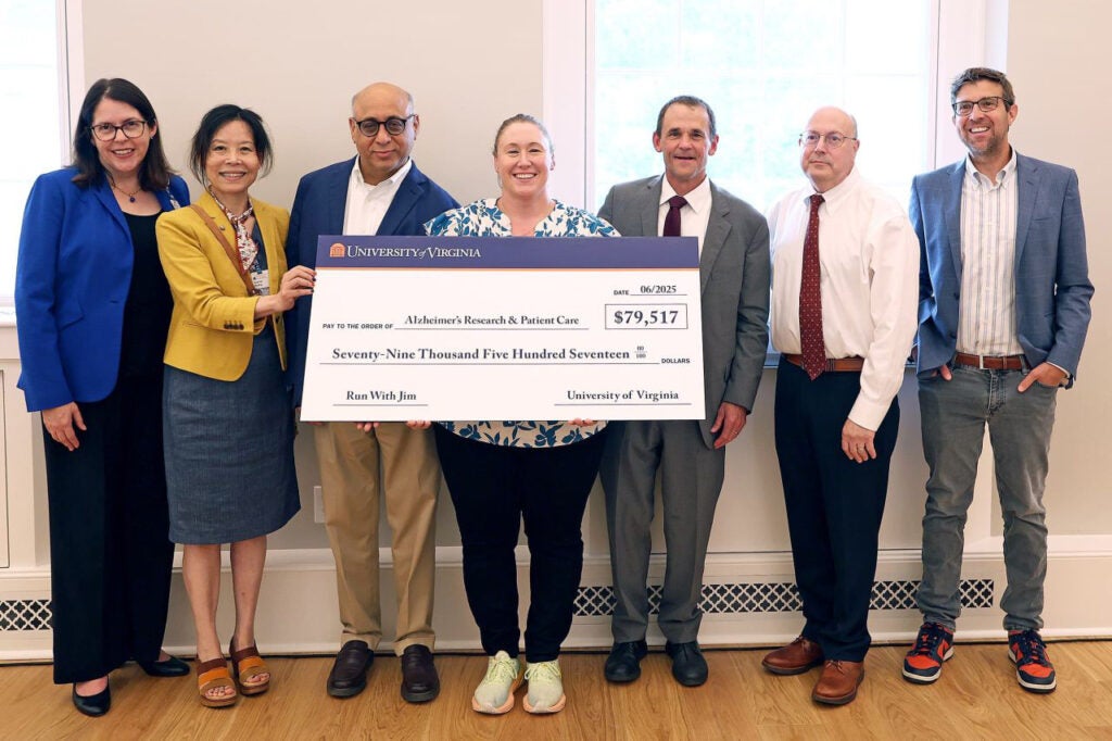 Members of UVA’s leadership community present a check earlier this year to commemorate UVA President Jim Ryan’s “Run With Jim” Boston Marathon campaign. From left to right: Senior Associate Vice President for Health System Development Amy Karr, Department of Neurology Chair Dr. Xuemei Huang, Brain Institute Co-Director Dr. Jaideep Kapur, Brain Institute Co-Director Sarah Kucenas, Jim Ryan, Interim Executive Vice President for Health Affairs Dr. Mitch Rosner, and John Lukens, director of the Harrison Center for Translational Alzheimer’s and Neurodegeneration. (Photo by Matt Riley, University Communications)