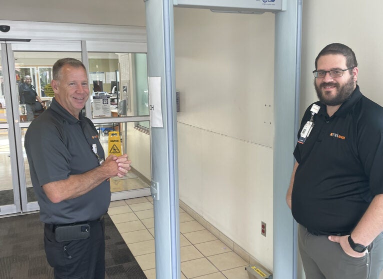 Michael Prailey, CHPA, CHSS, (left), Director for Emergency Management/Public Safety; and Michael Bednar MHA, CHPA, CHEC-III, Emergency Preparedness Manager, are shown with one of the new metal detectors at UVA Health Prince William Medical Center.