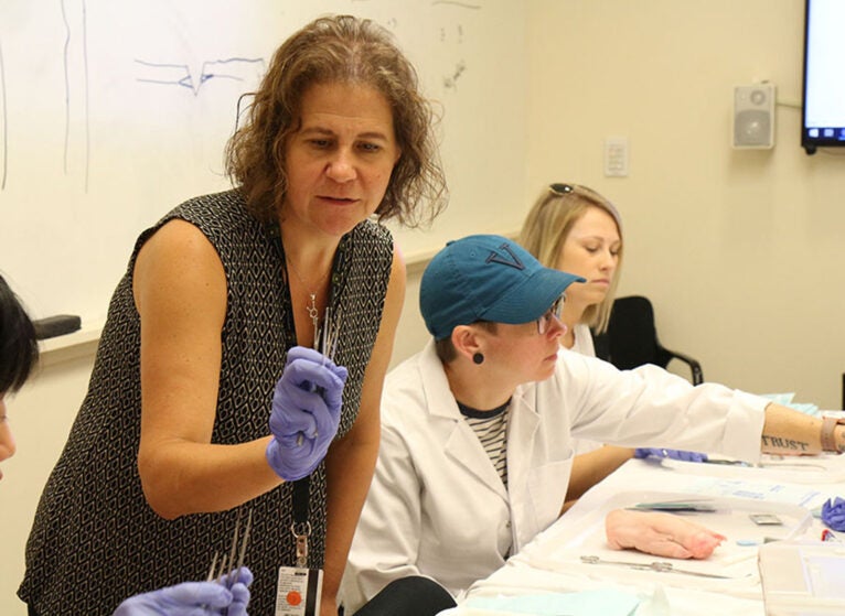 Yost with family nurse practitioner students in the simulation lab in 2022.