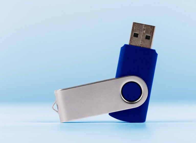 Close-Up Of Usb Stick Against blue Background
