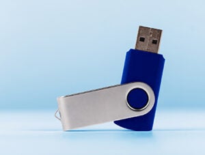 Close-Up Of Usb Stick Against blue Background