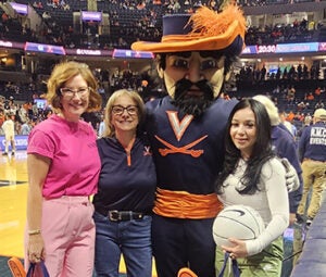 team members on the basketball court with CavMan