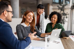 Office professionals exchange ideas during a collaborative meeting, fostering creativity and teamwork in a professional space.